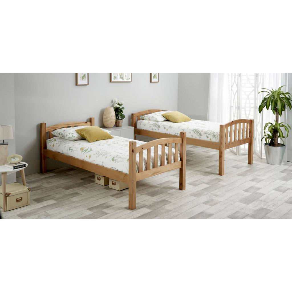 Mya Pine Bunk Bed in natural pine in furnished bedroom. The bunks have been split into two single beds